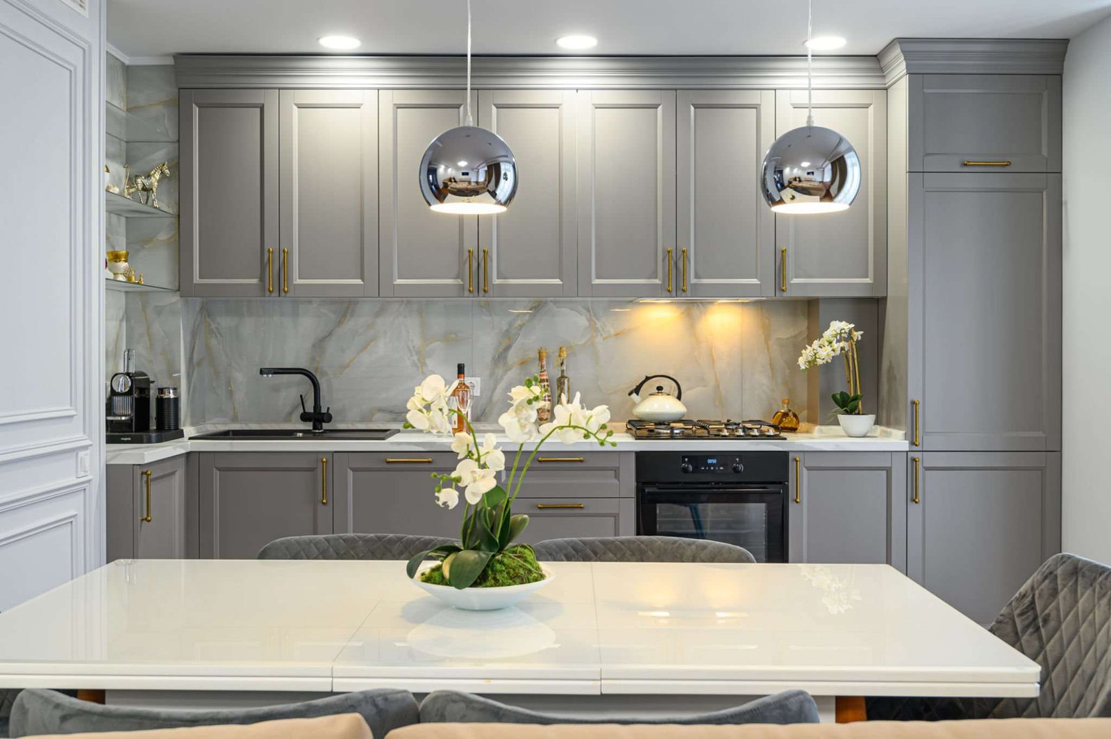 contemporary classic kitchen interior with dining table designed in modern style, with quartz worktops